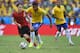 FORTALEZA, BRAZIL - JUNE 17: Paulinho of Brazil takes on Andres Guardado of Mexico during the 2014 FIFA World Cup Brazil Group A match between Brazil and Mexico at Castelao on June 17, 2014 in Fortaleza, Brazil. (Photo by Laurence Griffiths/Getty Images)