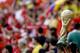 A spectator holds up a replica of the World Cup trophy after the group E World Cup soccer match between Switzerland and Ecuador at the Estadio Nacional in Brasilia, Brazil, Sunday, June 15, 2014. (AP Photo/Michael Sohn)