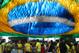 Soccer fans walk below a street decoration of the Brazilian flag, during the Brazil soccer World Cup match against Cameroon, in Manaus, Brazil, Monday, June 23, 2014. Brazil's Neymar scored twice in the first half to lead Brazil to a 4-1 win over Cameroon on Monday, helping the hosts secure a spot in the second round of the soccer World Cup. (AP Photo/Martin Mejia)