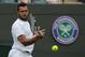 Jo-Wilfried Tsonga of France plays a return to Juergen Melzer of Austria during their first round match at the All England Lawn Tennis Championships in Wimbledon, London, Monday, June 23, 2014. (AP Photo/Ben Curtis)