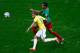 BRASILIA, BRAZIL - JUNE 23: Neymar of Brazil competes for the ball with Joel Matip of Cameroon during the 2014 FIFA World Cup Brazil Group A match between Cameroon and Brazil at Estadio Nacional on June 23, 2014 in Brasilia, Brazil. (Photo by Phil Walter/Getty Images)