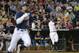 Virginia third baseman Kenny Towns (9) handles a ground ball as Vanderbilt right fielder Rhett Wiseman runs safely to first base in the seventh inning of game one of the best-of-three NCAA baseball College World Series finals in Omaha, Neb., Monday, June 23, 2014. (AP Photo/Ted Kirk)