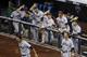 Players in the Virginia dugout celebrate after Virginia's Brandon Downes hit an RBI triple in the sixth inning of Game 2 of the best-of-three NCAA baseball College World Series finals against Vanderbilt in Omaha, Neb., Tuesday, June 24, 2014. (AP Photo/Nati Harnik)