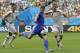 Bosnia's Edin Dzeko, center, gets in a shot despite the challenge of Iran's Jalal Hosseini, right, during the group F World Cup soccer match between Bosnia and Iran at the Arena Fonte Nova in Salvador, Brazil, Wednesday, June 25, 2014. (AP Photo/Sergei Grits)