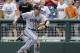 Virginia first baseman Mike Papi, center, reacts after catching a foul ball hit to the stands by Mississippi's Will Allen to end the fifth inning of an NCAA College World Series baseball game in Omaha, Neb., Saturday, June 21, 2014. (AP Photo/Eric Francis)