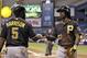 Pittsburgh Pirates' Andrew McCutchen, right, shakes hands with on-deck batter Josh Harrison after scoring on an RBI single by Russell Martin during the first inning of an interleague baseball game Monday, June 23, 2014, in St. Petersburg, Fla. (AP Photo/Chris O'Meara)
