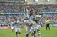 Argentina's Lionel Messi, left, is carried by his teammates Argentina's Angel di Maria (7) and Argentina's Marcos Rojo after scoring his side's first goal during the group F World Cup soccer match between Nigeria and Argentina at the Estadio Beira-Rio in Porto Alegre, Brazil, Wednesday, June 25, 2014. (AP Photo/Martin Meissner)