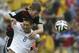 Germany's Per Mertesacker, back, and United States' Clint Dempsey go for a header during the group G World Cup soccer match between the USA and Germany at the Arena Pernambuco in Recife, Brazil, Thursday, June 26, 2014. (AP Photo/Petr David Josek)