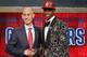 NBA Commissioner Adam Silver, left, congratulates Andrew Wiggins of Kansas who was selected by the Cleveland Cavaliers as the number one pick in the 2014 NBA draft, Thursday, June 26, 2014, in New York. (AP Photo/Jason DeCrow)