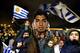 Fans of Uruguay's national soccer team await the arrival of Uruguay player Luis Suarez at Carrasco International Airport in the outskirts of Montevideo, Uruguay, Thursday, June 26, 2014. The Uruguay forward, widely regarded as one of the best players in the world, was banned by FIFA from all football for four months on Thursday for biting an Italian opponent in an incident that marred the team's victory and progression to the second round. (AP Photo/Matilde Campodonico)
