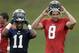 St. Louis Rams wide receiver Tavon Austin, left, and quarterback Sam Bradford put on the helmets during training camp at the NFL football team's practice facility Monday, July 29, 2013, in St. Louis. (AP Photo/Jeff Roberson)