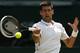 Novak Djokovic of Serbia plays a return to Gilles Simon of France during their men's singles match at the All England Lawn Tennis Championships in Wimbledon, London, Friday, June 27, 2014. (AP Photo/Sang Tan)