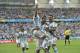 Argentina's Lionel Messi, left, is carried by his teammates Argentina's Angel di Maria (7) and Argentina's Marcos Rojo after scoring his side's first goal during the group F World Cup soccer match between Nigeria and Argentina at the Estadio Beira-Rio in Porto Alegre, Brazil, Wednesday, June 25, 2014. (AP Photo/Martin Meissner)