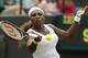 Serena Williams of U.S. plays a return to Chanelle Scheepers of South Africa during their women's singles match at the All England Lawn Tennis Championships in Wimbledon, London, Thursday, June 26, 2014. (AP Photo/Ben Curtis)
