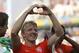 Netherlands' Dirk Kuyt forms a heart with his hands after the group B World Cup soccer match between the Netherlands and Chile at the Itaquerao Stadium in Sao Paulo, Brazil, Monday, June 23, 2014. The Dutch team beat Chile 2-0 to top Group B. (AP Photo/Frank Augstein)