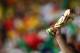 BELO HORIZONTE, BRAZIL - JUNE 17: A fan holds up a replica of the World Cup trophy during the 2014 FIFA World Cup Brazil Group H match between Belgium and Algeria at Estadio Mineirao on June 17, 2014 in Belo Horizonte, Brazil. (Photo by Quinn Rooney/Getty Images)