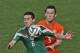 Mexico's Hector Herrera, left, and Netherlands' Stefan de Vrij challenge for the ball during the World Cup round of 16 soccer match between the Netherlands and Mexico at the Arena Castelao in Fortaleza, Brazil, Sunday, June 29, 2014. (AP Photo/Themba Hadebe)