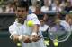 Novak Djokovic of Serbia plays a return against Gilles Simon of France during the men's singles match at the All England Lawn Tennis Championships in Wimbledon, London, Friday, June 27, 2014. (AP Photo/Sang Tan)