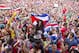 Costa Rica soccer fans celebrate a goal against Greece as they watch the World Cup round of 16 match on TV set up in a public square in San Jose, Costa Rica, Sunday, June 29, 2014. (AP Photo/Esteban Felix)