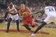 Houston Rockets' Jeremy Lin (7) drives against Portland Trail Blazers' Thomas Robinson (41) and Mo Williams (25) during the first half of game six of an NBA basketball first-round playoff series game in Portland, Ore., Friday May 2, 2014. (AP Photo/Greg Wahl-Stephens)
