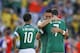 Mexico's Miguel Layun (7) is hugged by his teammate Marco Fabian after the Netherlands defeated Mexico 2-1 to advance to the quarterfinals during the World Cup round of 16 soccer match between the Netherlands and Mexico at the Arena Castelao in Fortaleza, Brazil, Sunday, June 29, 2014. (AP Photo/Eduardo Verdugo)
