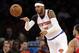 New York Knicks' Carmelo Anthony, left, passes the ball past Chicago Bulls' D.J. Augustin during the first half of the NBA basketball game, Sunday, April 13, 2014 in New York. The Knicks defeated the Bulls 100-89. (AP Photo/Seth Wenig)