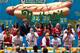 NEW YORK, NY - JULY 04: Competitive eaters compete in the men's division of the Nathan's Famous International Hot Dog Eating Contest at Coney Island on July 4, 2012 in the Brooklyn borough of New York City. Joey Chestnut won the men's division by successfully tying his own world record by eating 68 hot dogs in 10 minutes; he has now won the competition six years in a row. (Photo by Andrew Burton/Getty Images)