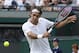 Roger Federer of Switzerland plays a return to Tommy Robredo of Spain in their men's singles match at the All England Lawn Tennis Championships in Wimbledon, London, Tuesday July 1, 2014. (AP Photo/Pavel Golovkin)