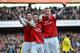 LONDON, ENGLAND - FEBRUARY 22: Laurent Koscielny of Arsenal (C) celebrates with team-mates Olivier Giroud of Arsenal (L) and Per Mertesacker of Arsenal after scoring their third goal during the Barclays Premier League match between Arsenal and Sunderland at Emirates Stadium on February 22, 2014 in London, England. (Photo by Michael Regan/Getty Images)