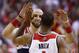 Washington Wizards forward Trevor Ariza (1) receives a high five from Washington Wizards center Marcin Gortat from Poland (4) during the second half of Game 4 of an opening-round NBA basketball playoff series in Washington, Sunday, April 27, 2014. The Washington Wizards defeated the Chicago Bulls 98-89 to lead the series 3-1. (AP Photo/Alex Brandon)