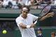 Roger Federer of Switzerland plays a return to Tommy Robredo of Spain in their men's singles match at the All England Lawn Tennis Championships in Wimbledon, London, Tuesday July 1, 2014. (AP Photo/Pavel Golovkin)