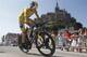 Britain's Chris Froome passes world heritage site Mont-Saint-Michel, rear, a rocky tidal island which holds a monastery, during the eleventh stage of the Tour de France cycling race, an individual time trial over 33 kilometers (20.6 miles) with start in in Avranches and finish in Mont-Saint-Michel, western France, Wednesday July 10 2013. (AP Photo/Laurent Cipriani)