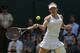 Simona Halep of Romania plays a return to Sabine Lisicki of Germany dduring their women's singles quarterfinal match at the All England Lawn Tennis Championships in Wimbledon, London, Wednesday, July 2, 2014. (AP Photo/Pavel Golovkin)
