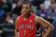 Toronto Raptors guard Kyle Lowry looks on against the Denver Nuggets in the third quarter of the Raptors' 100-90 victory in an NBA basketball game in Denver on Friday, Jan. 31, 2014. (AP Photo/David Zalubowski)