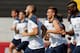 France's Karim Benzema, left front, smiles with Antoine Griezmann, center right, while running during a training session at the Santa Cruz stadium, in Ribeirao Preto, Brazil, Wednesday, July 2, 2014. France will face Germany in their World Cup quarterfinal, next Friday. (AP Photo/David Vincent)