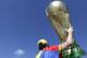 A fan of Brazil national soccer team holds up a replica of World Cup trophy prior the World Cup round of 16 match between Brazil and Chile at the Mineirao Stadium in Belo Horizonte, Brazil, Saturday, June 28, 2014. (AP Photo/Petr David Josek)