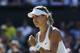 Eugenie Bouchard of Canada celebrates after winning the first set as she plays against Simona Halep of Romania during their women’s singles semifinal match at the All England Lawn Tennis Championships in Wimbledon, London, Thursday, July 3, 2014. (AP Photo/Ben Curtis)