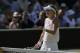 Eugenie Bouchard of Canada disputes a line call with the umpire as she plays against Simona Halep of Romania during their women's singles semifinal match at the All England Lawn Tennis Championships in Wimbledon, London, Thursday, July 3, 2014. (AP Photo/Pavel Golovkin)