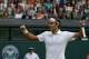 Roger Federer of Switzerland celebrates as he defeats Stan Wawrinka of Switzerland in their men's singles quarterfinal match at the All England Lawn Tennis Championships in Wimbledon, London, Wednesday, July 2, 2014. (AP Photo/Pavel Golovkin)