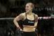 FILE - In this Feb. 22, 2014, file photo, Ronda Rousey looks around after defeating Sara McMann in a UFC 170 mixed martial arts women's bantamweight title bout in Las Vegas. Gina Carano was scheduled to meet with UFC President Dana White on Wednesday April 9, to discuss a return to mixed martial arts for a potential bout with bantamweight champion Rousey. (AP Photo/Isaac Brekken, File)