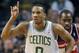 Boston Celtics' Avery Bradley (0) reacts in front of Washington Wizards' Martell Webster (9) after scoring a 3-pointer in the first quarter of an NBA basketball game in Boston, Saturday, Dec. 21, 2013. (AP Photo/Michael Dwyer)