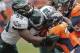 FILE - In this Sept. 29, 2013, file photo, Denver Broncos running back Knowshon Moreno (27) runs the ball against Philadelphia Eagles inside linebacker DeMeco Ryans (59) and outside linebacker Trent Cole (58) in the third quarter of an NFL football game,in Denver. Increasingly, teams are having trouble getting what they need on the ground on third or fourth down, with 2 or fewer yards needed for a first down or a touchdown. And increasingly, they're trying to pass for those short gains. (AP Photo/Joe Mahoney, File)