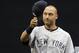 New York Yankees' Derek Jeter tips his cap to fans as he his honored during a pre-game ceremony before a baseball game against the Seattle Mariners, Tuesday, June 10, 2014, in Seattle. (AP Photo/Ted S. Warren)