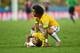FORTALEZA, BRAZIL - JULY 04: Neymar of Brazil lies on the field after a challenge as teammate Marcelo reacts during the 2014 FIFA World Cup Brazil Quarter Final match between Brazil and Colombia at Castelao on July 4, 2014 in Fortaleza, Brazil. (Photo by Jamie McDonald/Getty Images)