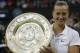 Petra Kvitova of Czech Republic holds the trophy after winning the women's singles final against Eugenie Bouchard of Canada at the All England Lawn Tennis Championships in Wimbledon, London, Saturday, July 5, 2014. (AP Photo/Sang Tan)