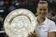 Petra Kvitova of Czech Republic holds the trophy after winning the women's singles final against Eugenie Bouchard of Canada at the All England Lawn Tennis Championships in Wimbledon, London, Saturday, July 5, 2014. (AP Photo/Sang Tan)