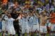 Argentina's Lionel Messi and teammates celebrate at the end of the World Cup quarterfinal soccer match between Argentina and Belgium at the Estadio Nacional in Brasilia, Brazil, Saturday, July 5, 2014. Argentina won 1-0. (AP Photo/Eraldo Peres)