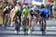 A teammate, rear, raises his arms as Germany's sprinter Marcel Kittel, second right, crosses the finish line ahead of second place Peter Sagan of Slovakia, third from right, third placed Ramunas Navardauskas of Lithuania, right, and fourth placed France's Bryan Coquard, left, to win the first stage of the Tour de France cycling race over 190.5 kilometers (118.4 miles) with start in Leeds and finish in Harrogate, England, Saturday, July 5, 2014. (AP Photo/Peter Dejong)