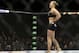 Ronda Rousey celebrates after defeating Alexis Davis in their women's mixed martial arts bantamweight title bout at UFC 175 Saturday, July 5, 2014, in Las Vegas. (AP Photo/John Locher)
