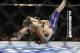 Ronda Rousey, left, takes down Alexis Davis during their women's mixed martial arts bantamweight title bout at UFC 175 on Saturday, July 5, 2014, in Las Vegas. (AP Photo/John Locher)
